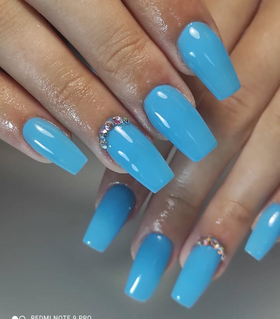 3. Glowing Blue Rhinestone Nails